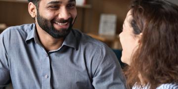 A picture of a man and a women speaking